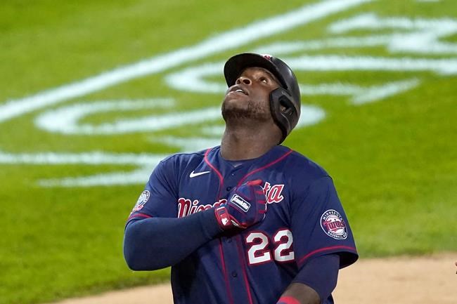 Minnesota Twins' Miguel Sano celebrates his two-run home run off Chicago White Sox relief pitcher Matt Foster during the eighth inning of a baseball game Wednesday, Sept. 16, 2020, in Chicago. Josh Donaldson scored on the homer. (AP Photo/Charles Rex Arbogast)