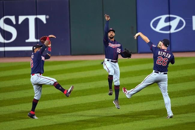 Minnesota Twins outfielders Eddie Rosario, Byron Buxton and Max Kepler, from left, celebrate the team's 5-1 win over the Chicago White Sox in a baseball game Wednesday, Sept. 16, 2020, in Chicago. (AP Photo/Charles Rex Arbogast)