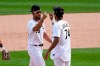 Chicago White Sox's Jose Abreu (79) and Eloy Jimenez celebrate the team's 4-3 win over the Minnesota Twins in baseball game Thursday, Sept. 17, 2020, in Chicago. The White Sox clinched a playoff spot for the first time since 2008. (AP Photo/Charles Rex Arbogast)