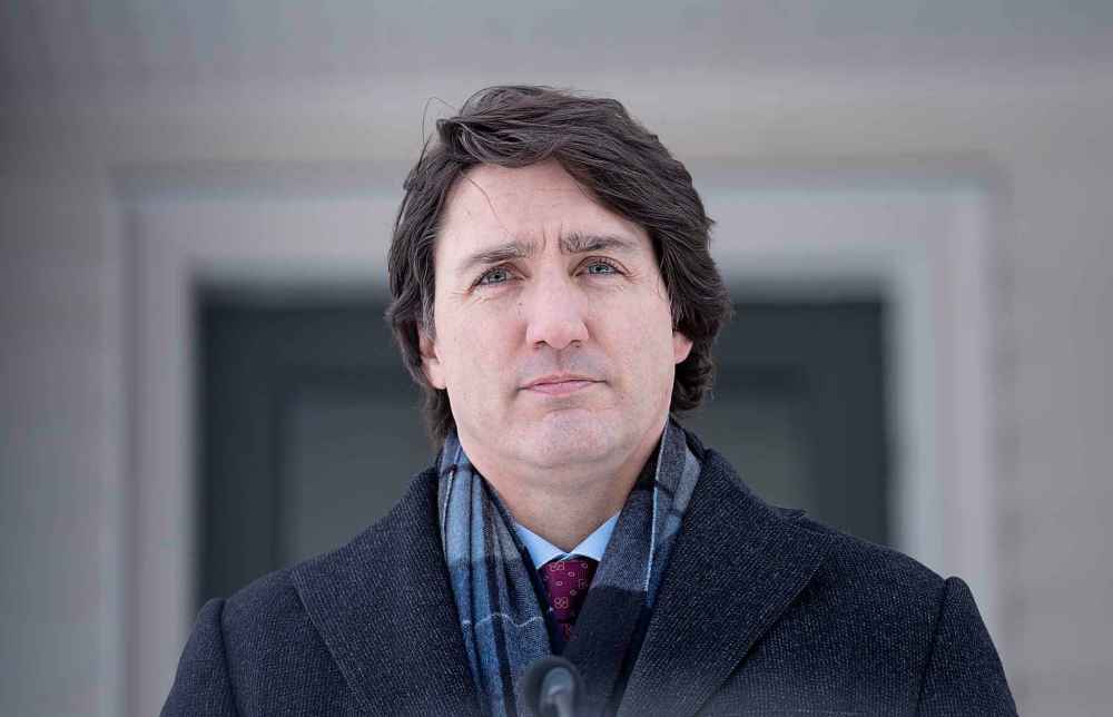 Canadian Prime Minister Justin Trudeau listens to a question as he participates in a media availability held at a location in the National Capital Region which is not being made public for security reasons, Monday, January 31, 2022. THE CANADIAN PRESS/Adrian Wyld