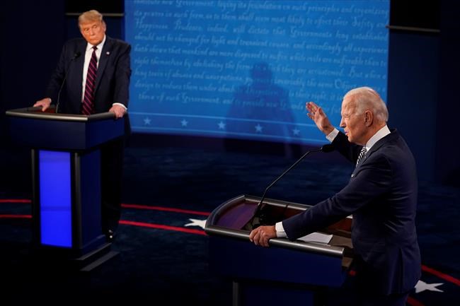 President Donald Trump listens to Democratic presidential candidate former Vice President Joe Biden during the first presidential debate Tuesday, Sept. 29, 2020, at Case Western University and Cleveland Clinic, in Cleveland, Ohio. (AP Photo/Morry Gash, Pool)
