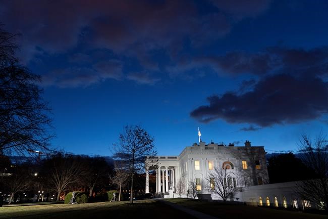The sun rises behind the White House at dawn, Wednesday, Jan. 20, 2021, in Washington. (AP Photo/Alex Brandon)