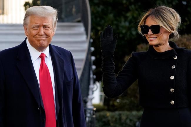 President Donald Trump and first lady Melania Trump stop to talk with the media as they walk to board Marine One on the South Lawn of the White House, Wednesday, Jan. 20, 2021, in Washington. Trump is en route to his Mar-a-Lago Florida Resort. (AP Photo/Alex Brandon)