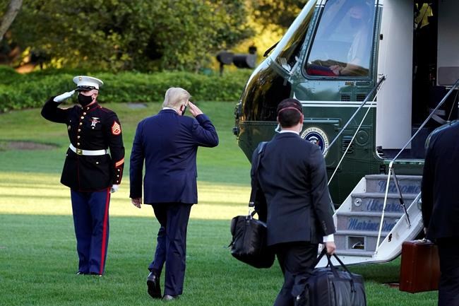 President Donald Trump salutes as he boards Marine One as he leaves the White House to go to Walter Reed National Military Medical Center after he tested positive for COVID-19, Friday, Oct. 2, 2020, in Washington. (AP Photo/Alex Brandon)