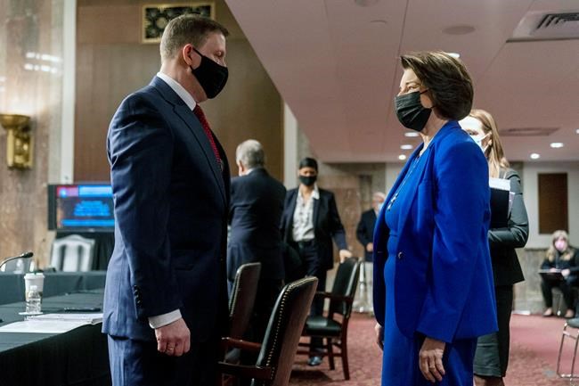 Former U.S. Capitol Police Chief Steven Sund, left, speaks with Chairwoman Sen. Amy Klobuchar, D-Minn., right, before he testifies before a Senate Homeland Security and Governmental Affairs & Senate Rules and Administration joint hearing on Capitol Hill, Washington, Tuesday, Feb. 23, 2021, to examine the January 6th attack on the Capitol. (AP Photo/Andrew Harnik, Pool)