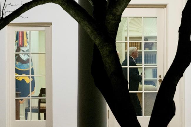 Vice President Mike Pence walks through the Oval Office before President Donald Trump departs the White House in Washington, Monday, Jan. 4, 2021, for a short trip to Andrews Air Force Base, Md., and then on to Dalton, Ga. for a rally. (AP Photo/Andrew Harnik)
