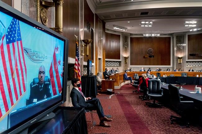 Washington Metropolitan Police Department Acting Chief of Police Robert Contee III, left, testifies via teleconference before a Senate Homeland Security and Governmental Affairs & Senate Rules and Administration joint hearing on Capitol Hill, Washington, Tuesday, Feb. 23, 2021, to examine the January 6th attack on the Capitol. (AP Photo/Andrew Harnik, Pool)