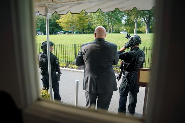 U.S. Secret Service Police stand outside the James Brady Press Briefing Room at the White House, Monday, Aug. 10, 2020, in Washington, as a news conference by President Donald Trump was paused. (AP Photo/Andrew Harnik)