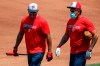 Washington Nationals' manager Dave Martinez, left, and bullpen coach Henry Blanco walk together during a baseball training camp workout at Nationals Stadium, Sunday, July 5, 2020, in Washington. (AP Photo/Carolyn Kaster)