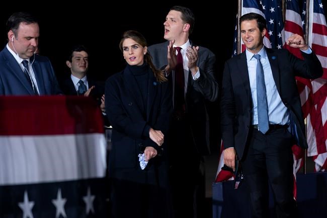 From left, White House director of social media Dan Scavino, Counselor to the President Hope Hicks, special assistant to the President and White House trip director William Russell, and director of the White House personnel John McEntee listen as President Donald Trump speaks during a campaign rally at Harrisburg International Airport, Saturday, Sept. 26, 2020, in Middletown, Pa. (AP Photo/Evan Vucci)