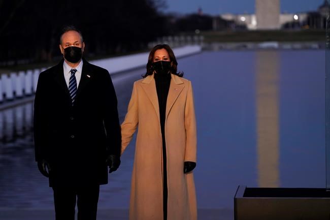 Vice President-elect Kamala Harris with her husband Doug Emhoff listen as Cardinal Wilton Daniel Gregory speaks during a COVID-19 memorial Tuesday, Jan. 19, 2021, in Washington. (AP Photo/Evan Vucci)