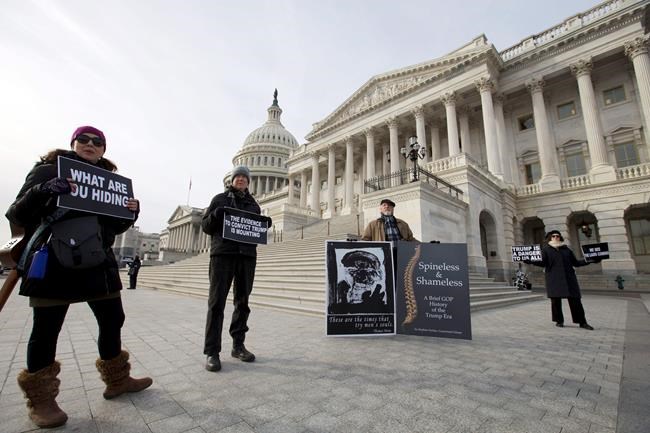 Demonstrators protest outside of the U.S. Capitol during the impeachment trial of President Donald Trump on charges of abuse of power and obstruction of Congress, at the Capitol in Washington, Thursday, Jan. 23, 2020.(AP Photo/Jose Luis Magana)