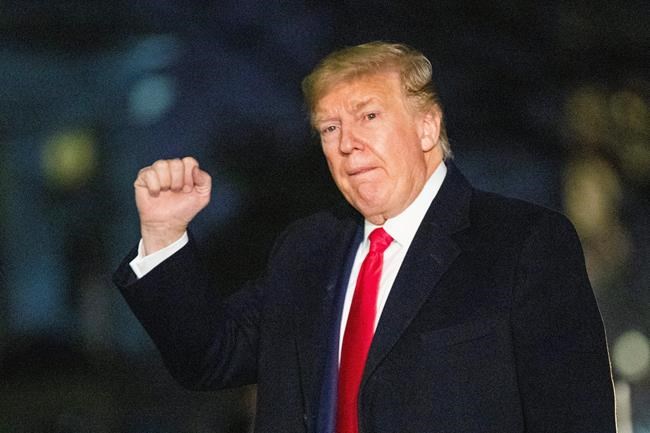 President Donald Trump gestures upon arrival at the White House, Wednesday, Jan. 22, 2020, in Washington, from the World Economic Forum in Davos, Switzerland, (AP Photo/Manuel Balce Ceneta)