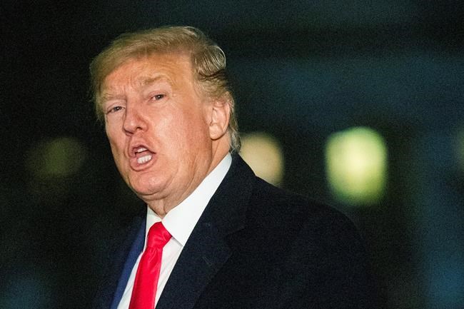 President Donald Trump responds to reporters upon arrival at the White House, Wednesday, Jan. 22, 2020, in Washington, from the World Economic Forum in Davos, Switzerland. (AP Photo/Manuel Balce Ceneta)