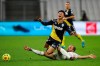 Monaco's Sofiane Diop reacts as he is tackled by Marseille's Valere Germain, right, during the French League One soccer match between Marseille and Monaco at the Stade Velodrome in Marseille, southern France, Saturday Dec. 12, 2020. (AP Photo/Daniel Cole)