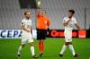 The referee shows Marseille's Valere Germain a yellow card during the French League One soccer match between Marseille and Monaco at the Stade Velodrome in Marseille, southern France, Saturday Dec. 12, 2020. (AP Photo/Daniel Cole)