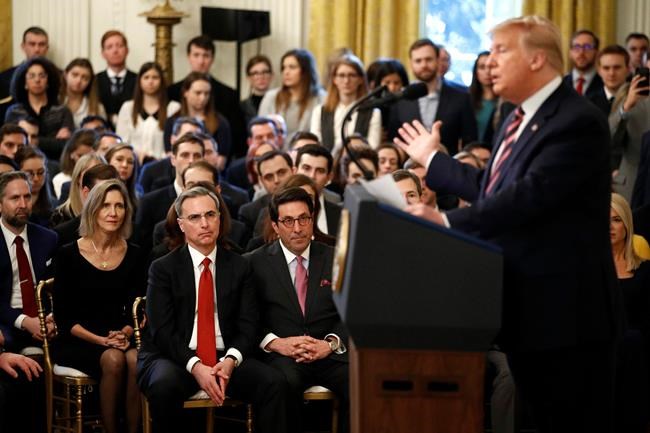 White House counsel Pat Cipollone, bottom left in red tie, and Jay Sekulow, President Donald Trump's personal lawyer, listen as Trump speaks in the East Room of the White House in Washington, Thursday, Feb. 6, 2020. (AP Photo/Patrick Semansky)