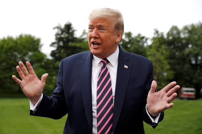 President Donald Trump speaks to members of the media on the South Lawn of the White House in Washington, Tuesday, May 5, 2020, before boarding Marine One for a short trip to Andrews Air Force Base, Md., and then on to Phoenix, Ariz. (AP Photo/Patrick Semansky)