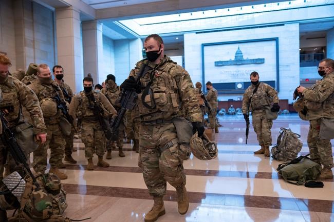Hundreds of National Guard troops hold inside the Capitol Visitor's Center to reinforce security at the Capitol in Washington, Wednesday, Jan. 13, 2021. The House of Representatives is pursuing an article of impeachment against President Donald Trump for his role in inciting an angry mob to storm the Capitol last week. (AP Photo/J. Scott Applewhite)