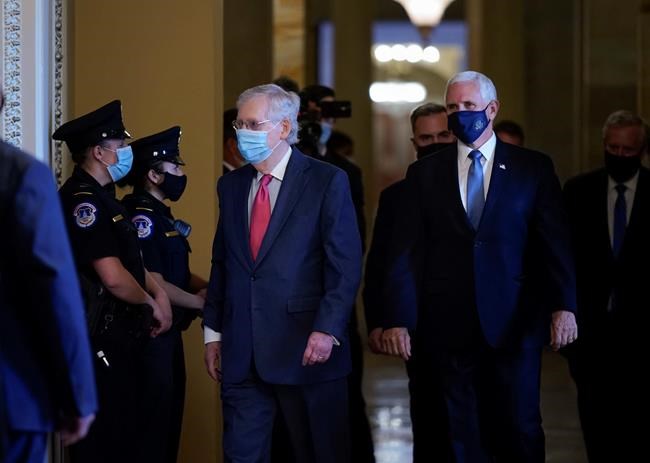 Senate Majority Leader Mitch McConnell, R-Ky., left, and Vice President Mike Pence, right, walk to hold a private meeting with Judge Amy Coney Barrett, President Donald Trump's nominee for the U.S. Supreme Court, at the Capitol in Washington, Tuesday, Sept. 29, 2020. (AP Photo/J. Scott Applewhite)