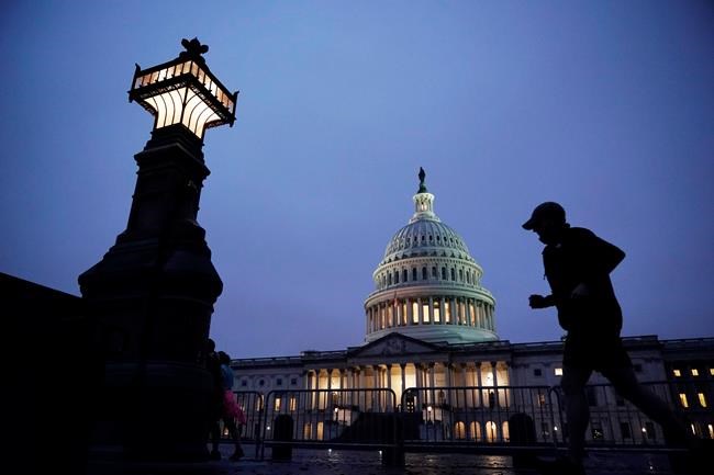 A jogger takes a early morning run at the Capitol, Monday, Oct. 26, 2020 in Washington, as Senate Republicans work toward the confirmation of Judge Amy Coney Barrett to the Supreme Court. (AP Photo/J. Scott Applewhite)