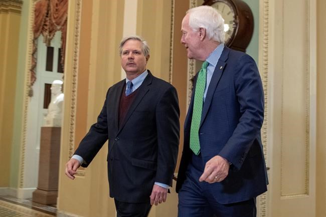 Sen. John Hoeven, R-N.D., left, talks with Sen. John Cornyn, R-Texas, as they walk to the Senate chamber prior to the start of the impeachment trial of President Donald Trump at the U.S. Capitol, Thursday, Jan. 23, 2020, in Washington. (AP Photo/Steve Helber)