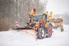 Clearing vehicles push piles of snow off a road in Bielefeld, Germany, Sunday, Feb. 7, 2021. (Marcel Kusch/dpa via AP)