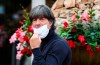 German national soccer team coach Joachim Loew takes off his mask as he arrives at the Wald-Hotel in Stuttgart, Germany, Monday, Aug. 31, 2020. Germany will play against Spain in the UEFA Nations League on Thursday, Sept. 3, 3030 in Stuttgart. (Christoph Schmidt/dpa via AP)
