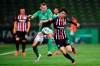 Bremen's Maximilian Eggestein, center, and Frankfurt's Daichi Kamada, right, fight for the ball during the German Bundesliga soccer match between SV Werder Bremen and Eintracht Frankfurt in Bremen, Germany, Wednesday, June 3, 2020. Because of the coronavirus outbreak all soccer matches of the German Bundesliga take place without spectators. (Stuart Franklin/Pool via AP)