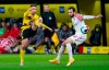 Dortmund's Raphael Guerreiro, left, and Mainz's Levin Oztunali battle for the ball during the Bundesliga soccer match between Borussia Dortmund and FSV Mainz 05 at Signal Iduna Park in Dortmund, Germany, Saturday Jan. 16, 2021. (Guido Kirchner/Pool via AP)