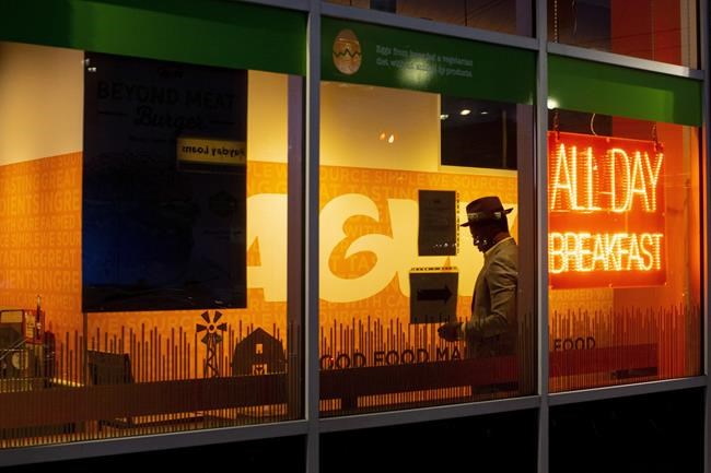A man waits for a take-out order in a fast food restaurant in Toronto on Saturday, May 9, 2020. THE CANADIAN PRESS/Chris Young