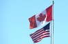 The Canadian and American flags are seen on top of the Peace Arch is at the Canada/USA border in Surrey, B.C. Friday, March 20, 2020. A new online poll suggests COVID-19 has damaged the trust Canadians have in their American neighbours, while U.S. residents have more faith in their northern counterparts than they do in themselves. THE CANADIAN PRESS/Jonathan Hayward