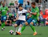 Then Vancouver Whitecaps player Felipe Martins (8) tries to control the ball in front of Seattle Sounders' Justin Dhillon in the first half of an MLS soccer match Saturday, June 29, 2019, in Seattle. Now playing for the D.C. United Martins has been suspended for one match and fined an undisclosed amount for serious foul play against Montreal Impact midfielder Victor Wanyama at the MLS is Back Tournament. THE CANADIAN PRESS/AP-Elaine Thompson
