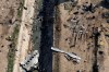 In this Wednesday, Jan. 8, 2020 photo, wreckage from a Ukrainian plane is seen on the ground and inside a water canal in Shahedshahr, southwest of the capital Tehran, Iran. Transport Minister Marc Garneau says Canada wants Iran to explain why it hasn't yet handed over the black boxes from the Ukrainian jetliner that crashed near Tehran on Jan. 8. THE CANADIAN PRESS/AP-Ebrahim Noroozi