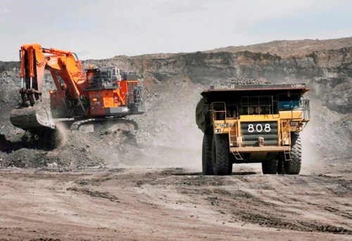 A haul truck carrying a full load drives away from a mining shovel at the Shell Albian Sands oilsands mine near Fort McMurray, Alta., Wednesday, July 9, 2008. THE CANADIAN PRESS/Jeff McIntosh