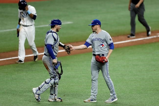 Toronto Blue Jays relief pitcher Ken Giles, right, celebrates with catcher Danny Jansen after closing out the Tampa Bay Rays during the ninth inning of a baseball game Friday, July 24, 2020, in St. Petersburg, Fla. Giles has been reinstated from the 45-day injured list and will be active for Friday's home game against the New York Mets. THE CANADIAN PRESS/AP-Chris O'Meara