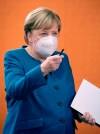 German Chancellor Angela Merkel wears a face mask as she arrives for the weekly cabinet meeting at the Chancellery in Berlin, Germany, Wednesday, Oct. 28, 2020. (Kay Nietfeld/dpa via AP, pool)