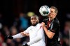 Cologne's Anthony Modeste, left, and Leverkusen's Sven Bender, right, challenge for the ball during the German Bundesliga soccer match between 1. FC Cologne and Bayer 04 Leverkusen in Cologne, Germany, Saturday, Dec. 14, 2019. (Marius Becker/dpa via AP)