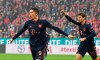 Munich's scorer Robert Lewandowski and his teammate Thomas Mueller celebrate the opening goal during the German Bundesliga soccer match between FSV Mainz 05 and FC Bayern Munich in Mainz, Germany, Saturday, Feb. 1, 2020. (Torsten Silz/dpa via AP)
