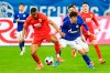 Augsburg's Felix Uduokhai, left, and Schalke's Klaas Jan Huntelaar, right, challenge for the ball during the German Bundesliga soccer match between FC Schalke 04 and FC Augsburg in Gelsenkirchen, Germany, Sunday, April 11, 2021. (Bernd Thissen/dpa via AP)
