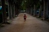 A boy wearing a shirt with the name of Barcelona soccer player Lionel Messi runs on a park in Banyoles, in Girona province, Spain on Wednesday, Sept. 2, 2020. Lionel Messi's future at Barcelona looked no closer to being resolved after the first meeting between the player's father and club officials on Wednesday ended without an agreement, a person with knowledge of the situation told The Associated Press. (AP Photo/Emilio Morenatti)