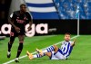 Real Sociedad's Portu reacts on the ground next to Real Madrid's Ferland Mendy during the Spanish La Liga soccer match between Real Sociedad and Real Madrid at the Anoeta stadium in San Sebastián, Spain, Sunday, Sept. 20, 2020. (AP Photo/Alvaro Barrientos)