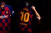 A worker holds a shirt with the name of Barcelona soccer player Lionel Messi at a F.C Barcelona store in Barcelona, Spain on Tuesday, Sept. 1, 2020. Barcelona is banking on a face-to-face meeting with Lionel Messi to try to convince him to stay. Talks with Messi’s father-agent are expected this week in Barcelona but the club also hopes to sit down with the player himself.(AP Photo/Emilio Morenatti)