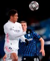Real Madrid's Raphael Varane fights for the ball against Atalanta's Mario Pasalic during the Champions League, round of 16, second leg soccer match between Atalanta and Real Madrid at the Alfredo di Stefano stadium in Madrid, Spain, Tuesday, March 16, 2021. (AP Photo/Bernat Armangue)