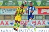Porto's Alex Telles jumps for the ball against Tondela's Fahd Moufi during the Portuguese league soccer match between Tondela and FC Porto and Leipzig at the Joao Cardoso stadium in Tondela, Portugal, Thursday, July 9, 2020. The Portuguese league soccer matches are being played without spectators because of the coronavirus pandemic. (AP Photo/Luis Vieira)