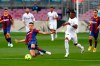 Barcelona's Sergio Busquets fights for the ball against Real Madrid's Vinicius Junior during the Spanish La Liga soccer match between FC Barcelona and Real Madrid at the Camp Nou stadium in Barcelona, Spain, Saturday, Oct. 24, 2020. (AP Photo/Joan Monfort)