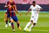 Real Madrid's Vinicius Junior fights for the ball against Barcelona's Sergino Dest during the Spanish La Liga soccer match between FC Barcelona and Real Madrid at the Camp Nou stadium in Barcelona, Spain, Saturday, Oct. 24, 2020. (AP Photo/Joan Monfort)
