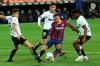 Barcelona's Antoine Griezmann fights for the ball against Valencia's Gabriel Paulista and Hugo Guillamon during the Spanish La Liga soccer match between Valencia and Barcelona at the Mestalla stadium in Valencia, Spain, Sunday, May 2, 2021. (AP Photo/Alberto Saiz)