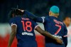 PSG's Kylian Mbappe, right celebrates with PSG's Moise Kean after scoring during the French League One soccer match between Paris Saint-Germain and Lorient at the Parc des Princes in Paris, France, Wednesday, Dec. 16, 2020. (AP Photo/Christophe Ena)