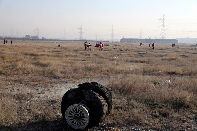 Debris is seen from an Ukrainian plane which crashed as rescue workers search the scene in Shahedshahr, southwest of the capital Tehran, Iran, Wednesday, Jan. 8, 2020. A Ukrainian airplane carrying 176 people crashed on Wednesday shortly after takeoff from Tehran's main airport, killing all onboard. (AP Photo/Ebrahim Noroozi)